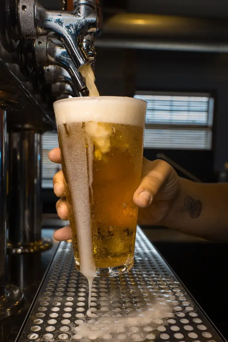 A cold draft beer being poured behind the bar at 212 A cold draft beer being poured behind the bar at 212